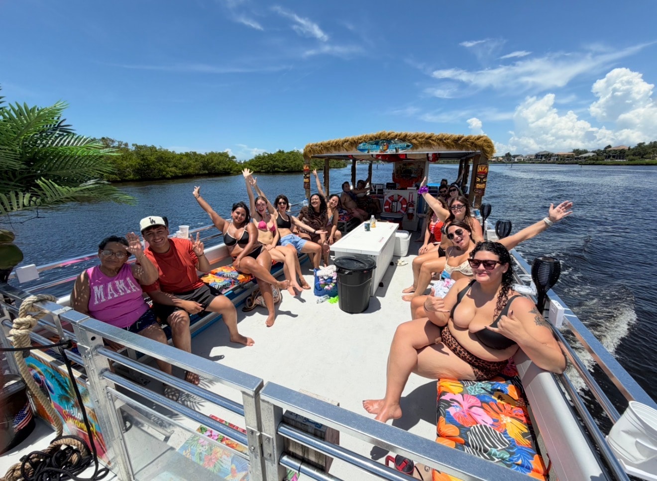Large group enjoying a tiki boat tour on the waterway
